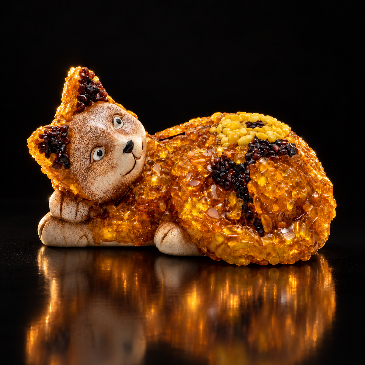 KIZIMA reclining amber-chip cat money box, on black with luminous amber highlights