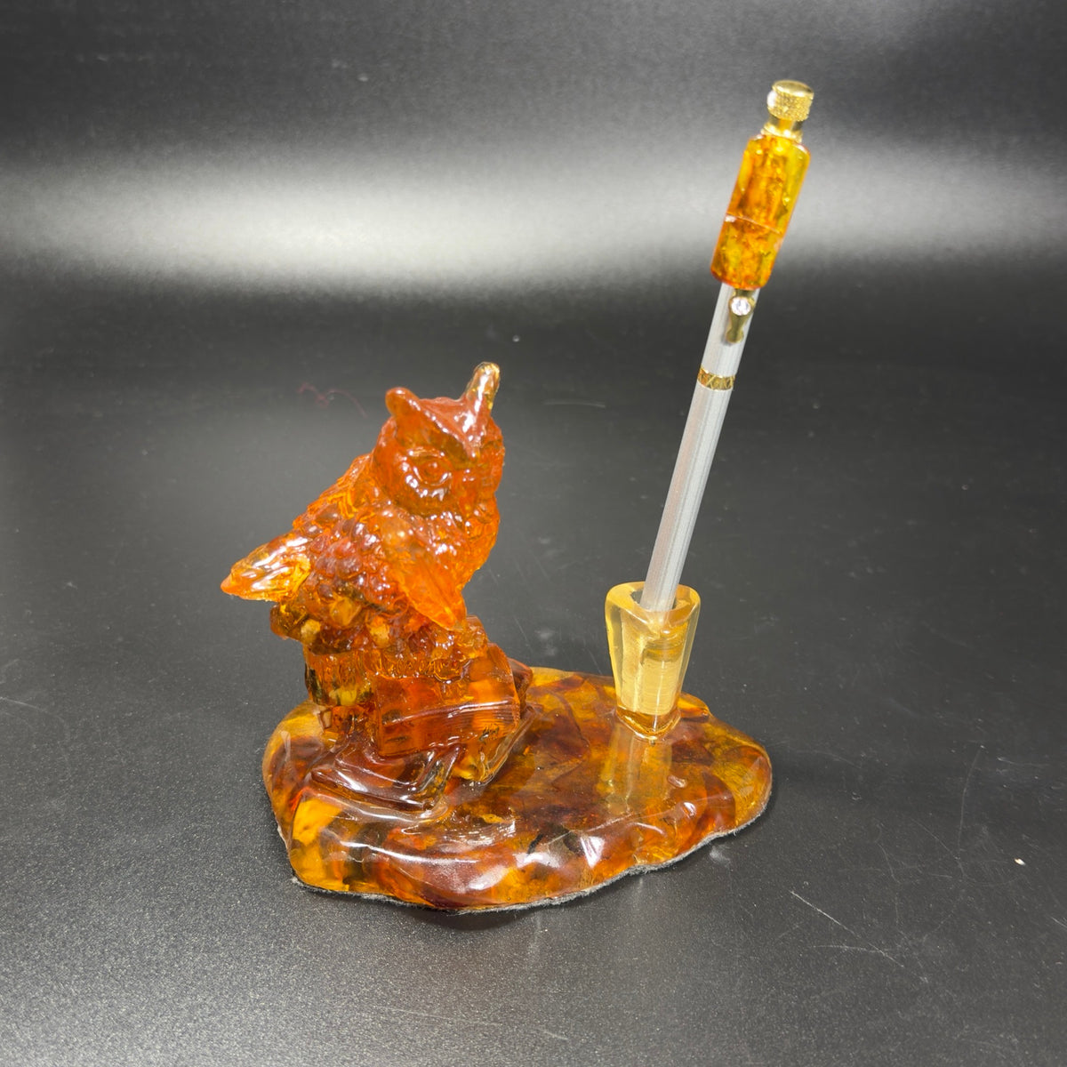 Original front photograph of owl pen stand with amber-topped silver pen