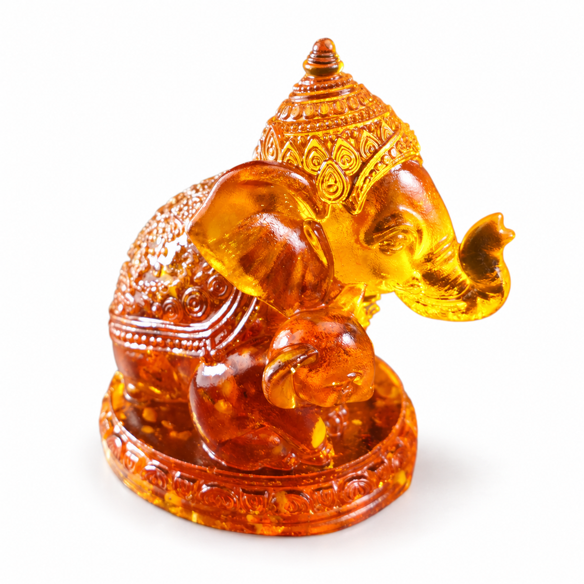 Natural Baltic Amber Ganesha statue by KIZIMA®, white background, glowing amber Ganesh idol for Diwali and yoga spaces