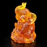 Made in USA Natural Baltic Amber seated elephant figurine, trunk up, honey amber good luck charm, black studio background — KIZIMA®