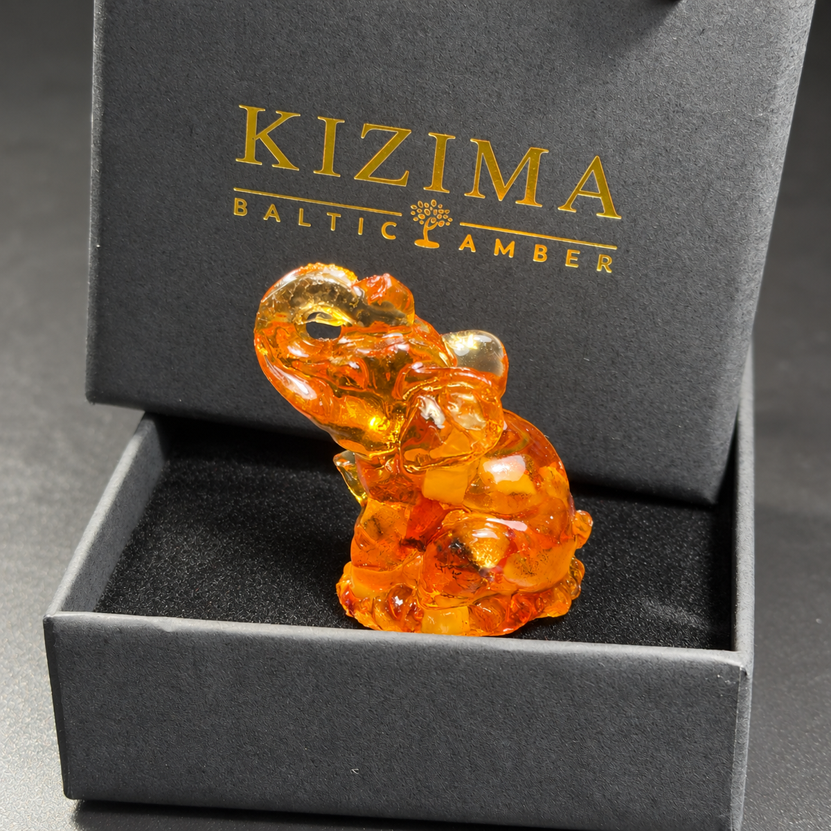 Baltic amber seated elephant figurine with KIZIMA® black gift box — ready-to-give good luck gift