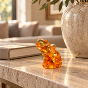 Baltic amber seated elephant figurine on a desk in a New York interior — handmade in Brooklyn by KIZIMA®