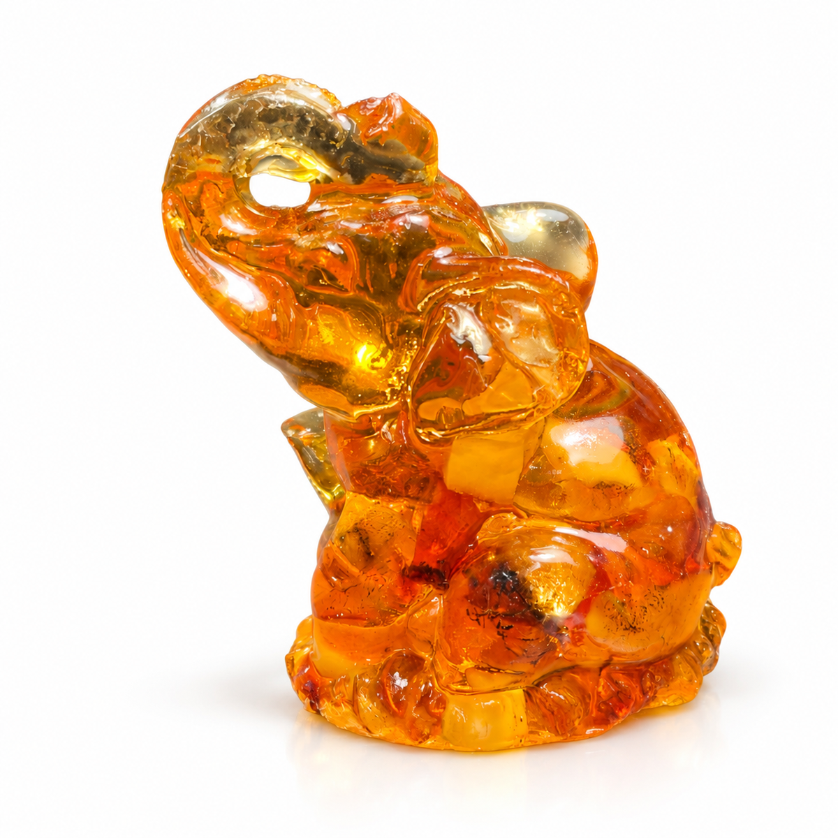 Natural Baltic Amber seated elephant figurine by KIZIMA®, white background — small lucky elephant gift