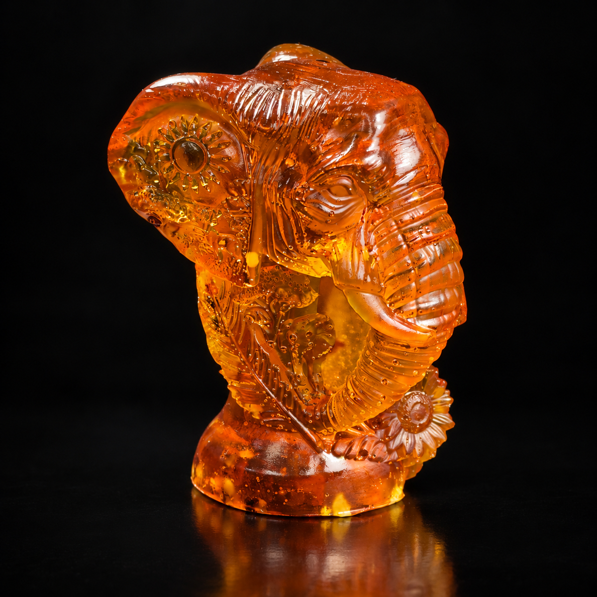 Made in USA Natural Baltic Amber Ganesha head statue, 10 cm elephant-god bust on lotus base, honey-cognac amber, black studio background — KIZIMA®
