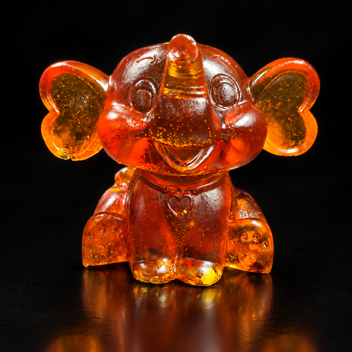 Made in USA Natural Baltic Amber cartoon baby elephant figurine, 8 cm, smiling big-eared elephant in cognac amber, black studio background — KIZIMA®