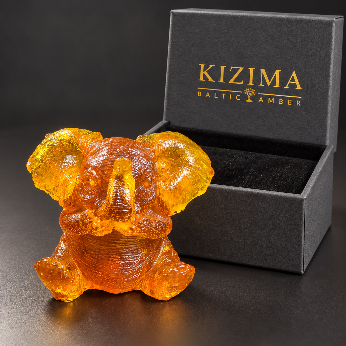 Baltic amber sitting baby elephant figurine with KIZIMA® black gift box — ready-to-give elephant gift