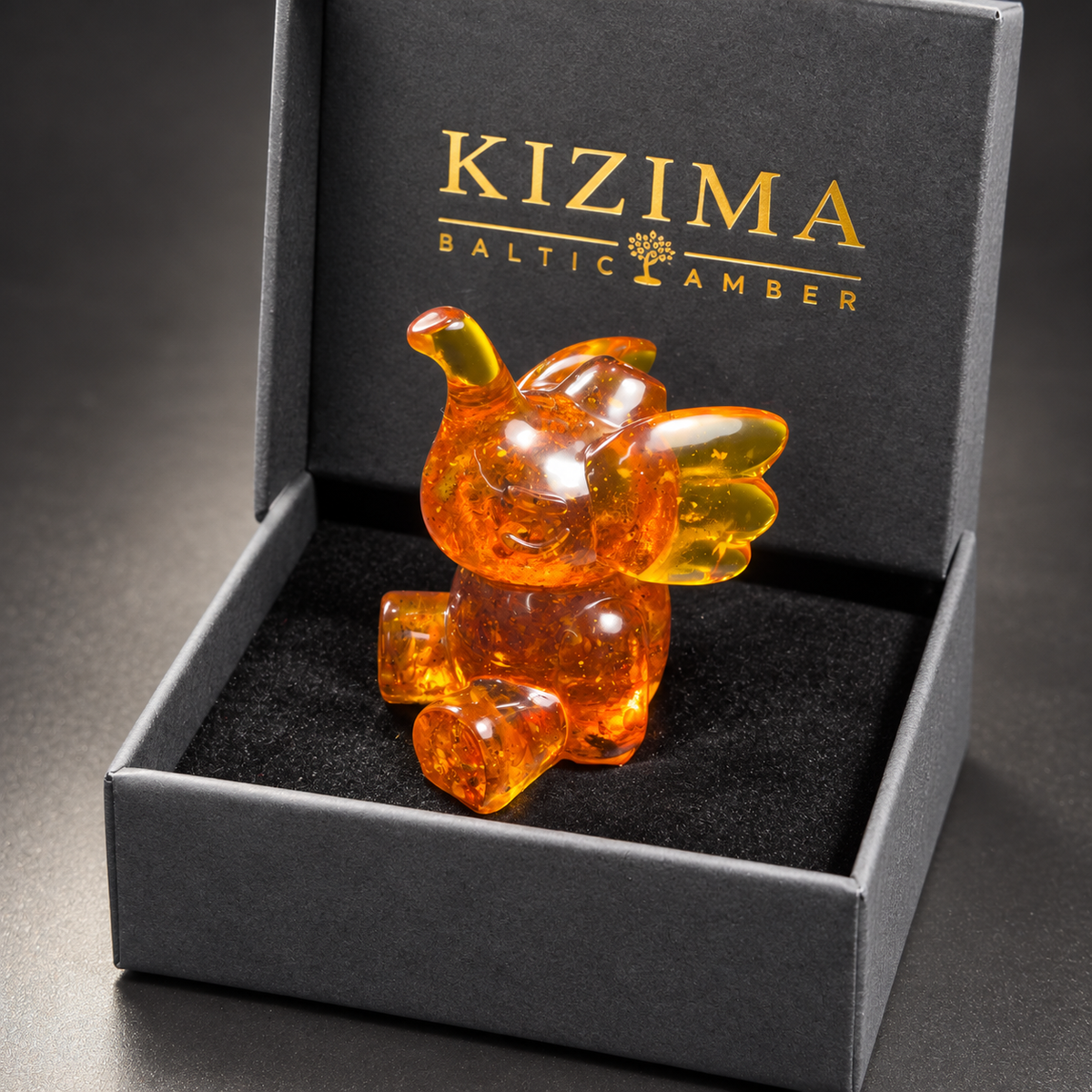 Baltic amber playful elephant figurine with KIZIMA® black gift box — ready-to-give elephant gift