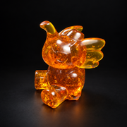 Made in USA Natural Baltic Amber playful elephant figurine, 7 cm sitting calf with raised trunk and flapping ears, honey amber, black studio background — KIZIMA®