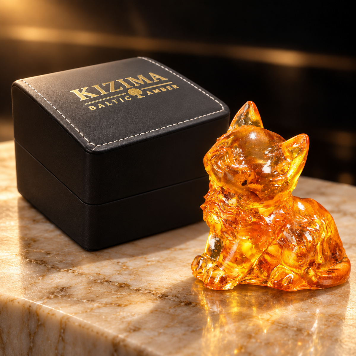 KIZIMA amber kitten beside the actual black stitched branded gift box