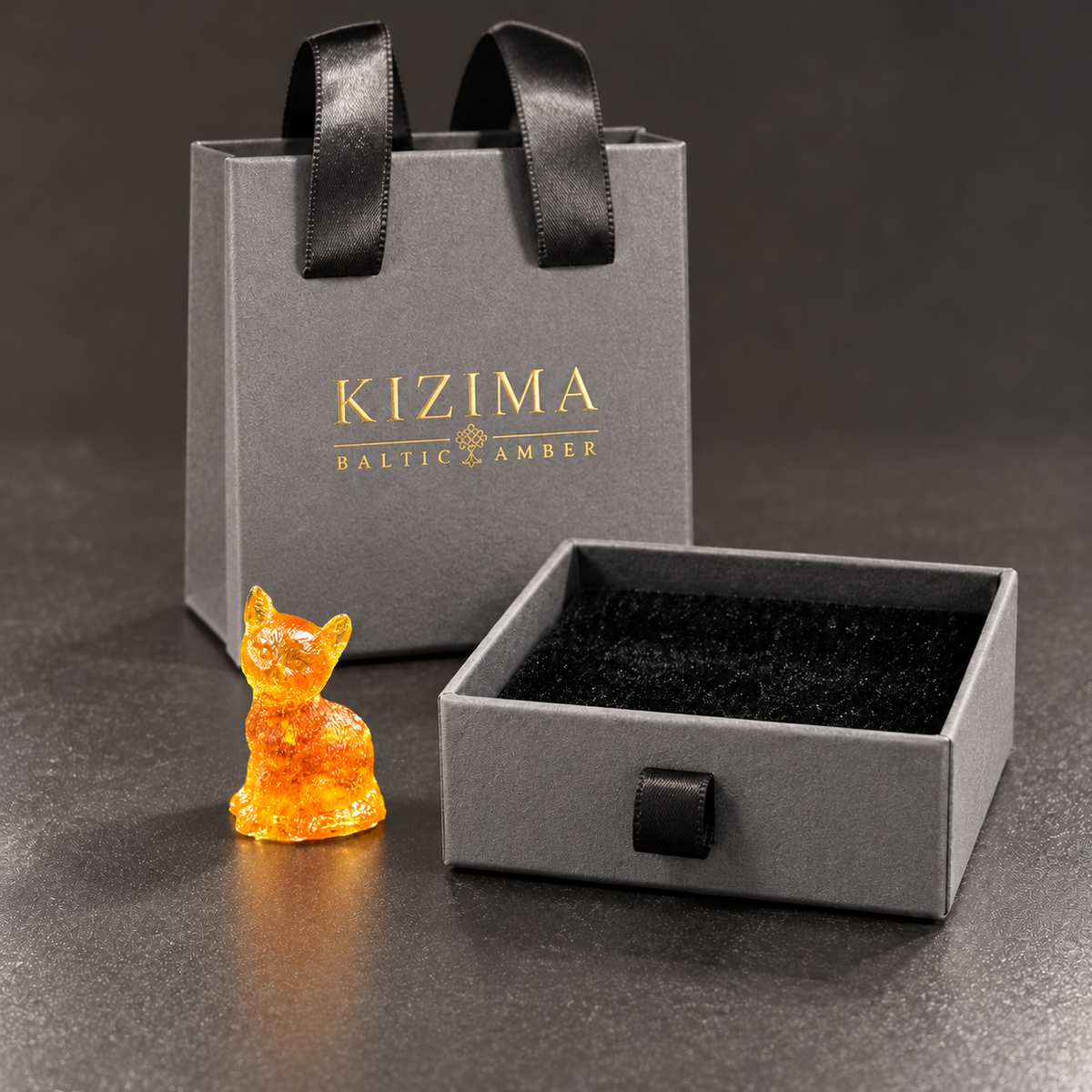 Made in USA Natural Baltic Amber mini cat figurine by KIZIMA® beside the small 8 x 8 x 3 cm KIZIMA® gift box