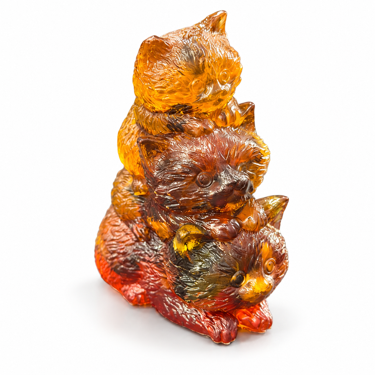 Made in USA Natural Baltic Amber three-kitten family sculpture by KIZIMA® with detailed fur and translucent golden, cognac and red tones on white