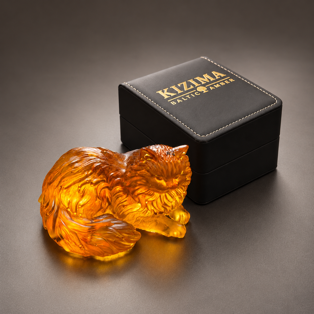 Made in USA Natural Baltic Amber Persian cat figurine by KIZIMA® beside the black KIZIMA® Baltic Amber gift box