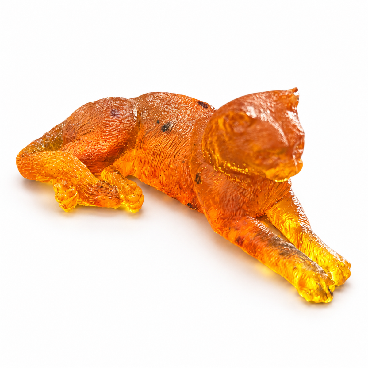 Made in USA Natural Baltic Amber reclining cat figurine by KIZIMA®, lying cat with extended front legs and curled tail on white