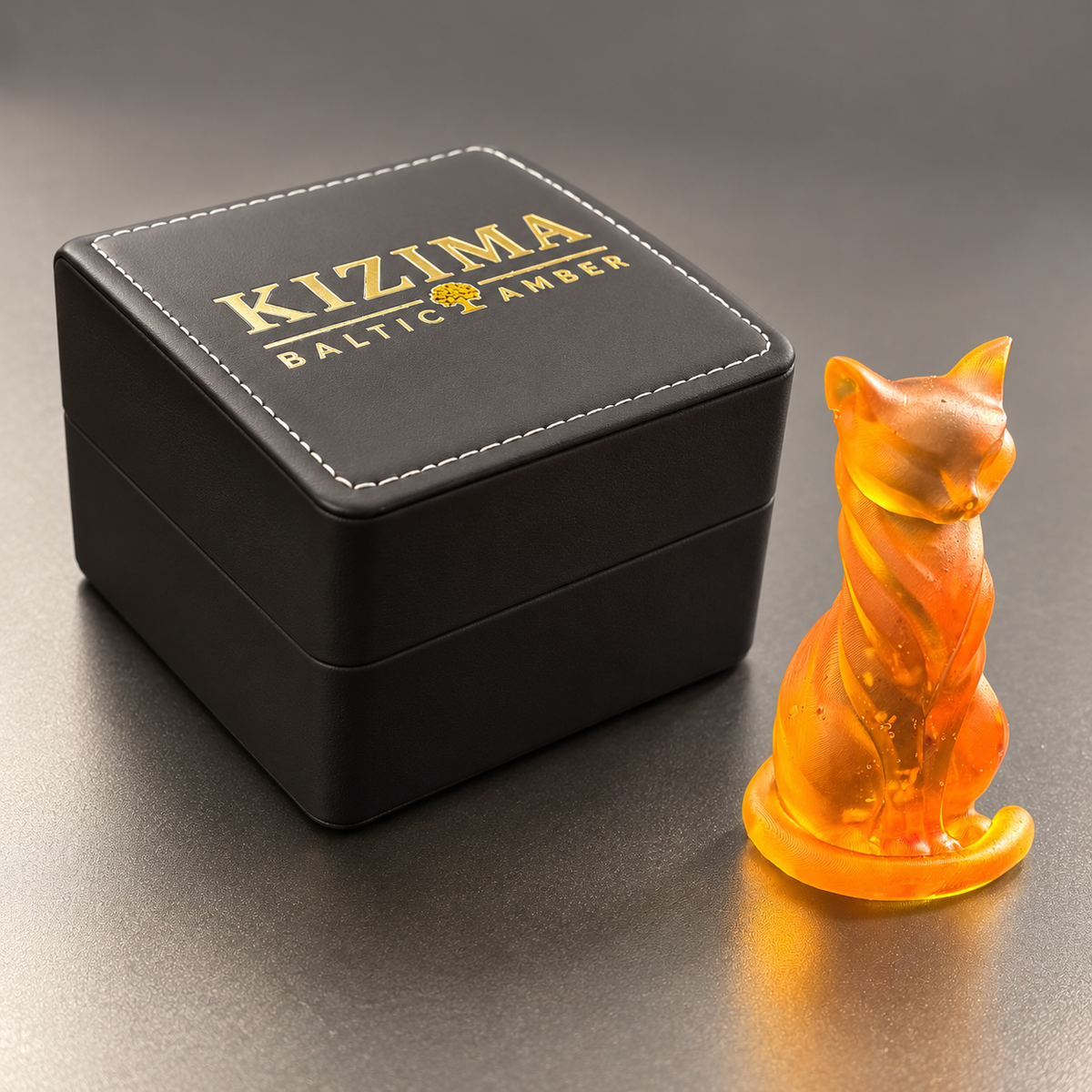 Made in USA Natural Baltic Amber slender cat figurine by KIZIMA® beside the black KIZIMA® Baltic Amber gift box