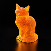 Made in USA Natural Baltic Amber sitting cat figurine by KIZIMA®, 8 cm orange-gold cat with textured fur and wrapped tail, black studio background
