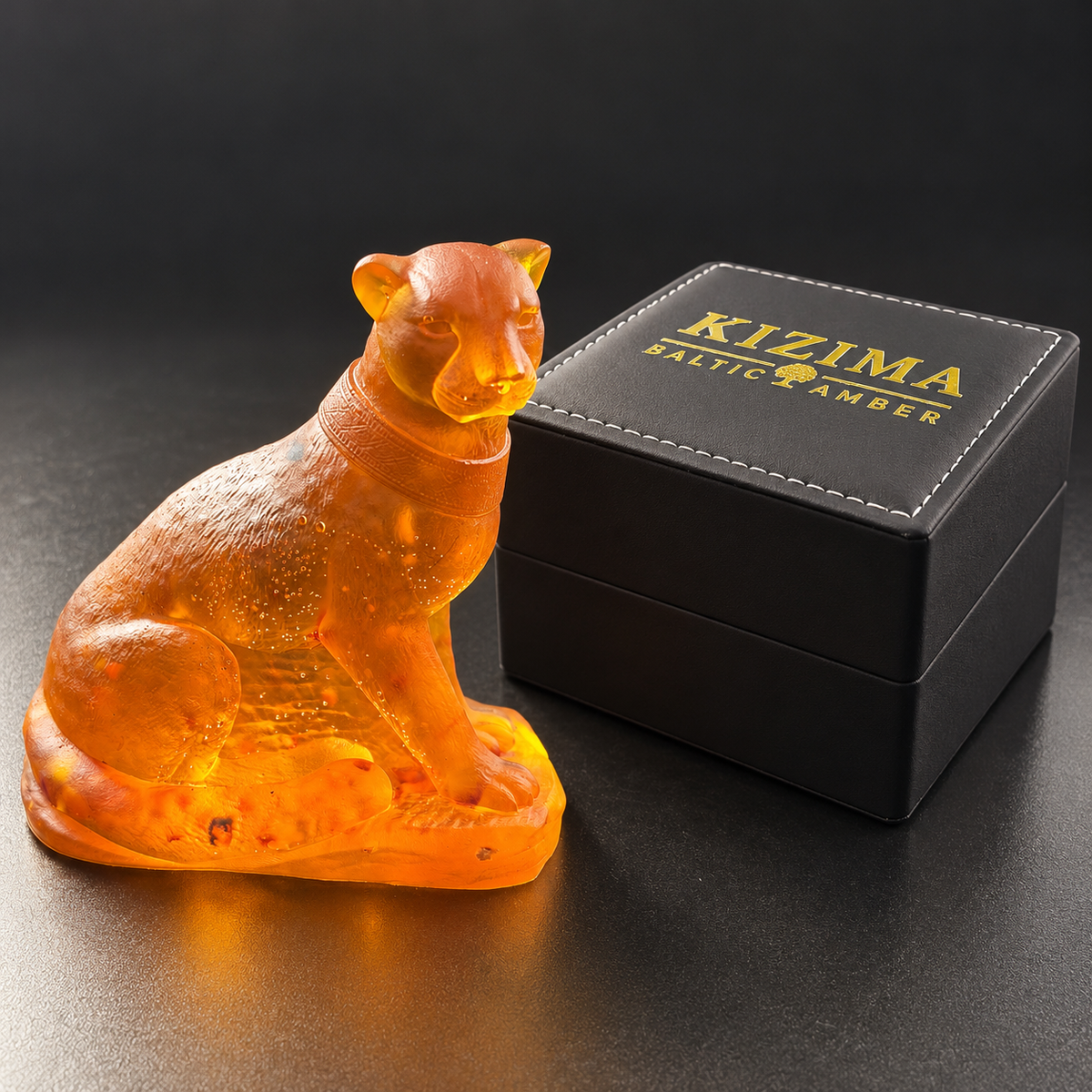 Made in USA Natural Baltic Amber panther figurine by KIZIMA® beside the black KIZIMA® gift box, shown at relative scale
