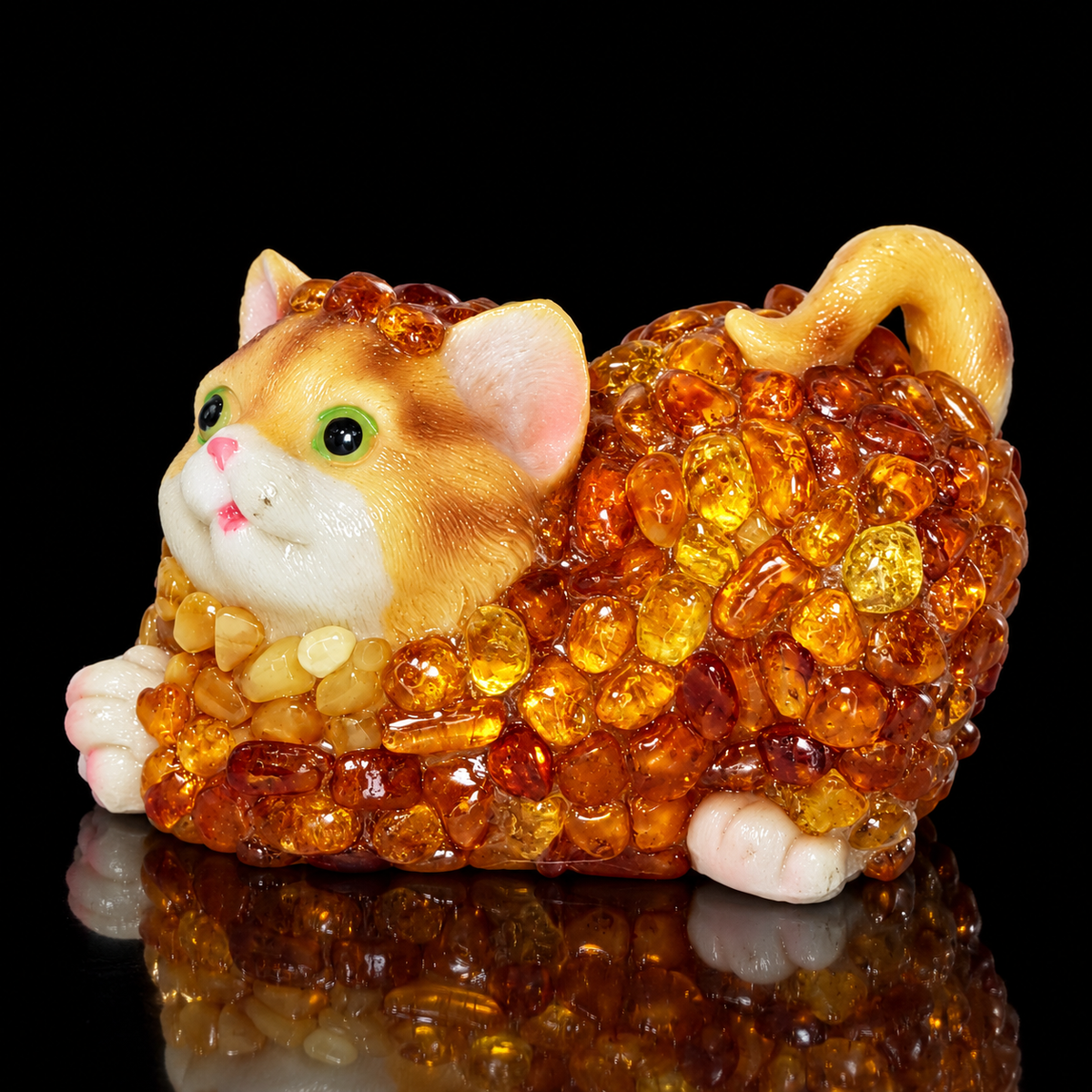 Natural Baltic Amber lying cat figurine by KIZIMA®, honey and cognac amber mosaic, black background, side view