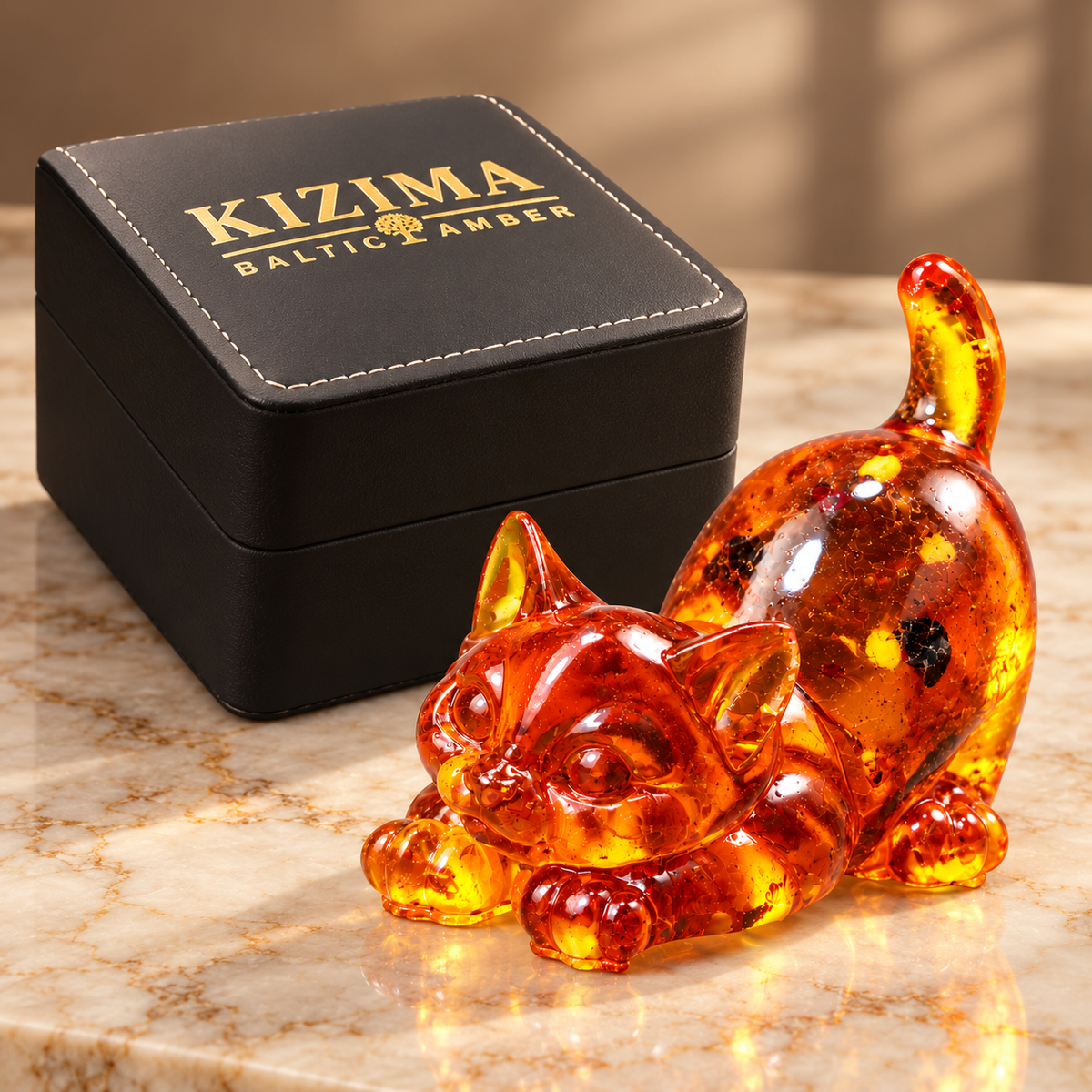 KIZIMA amber cat figurine beside the actual black stitched branded gift box