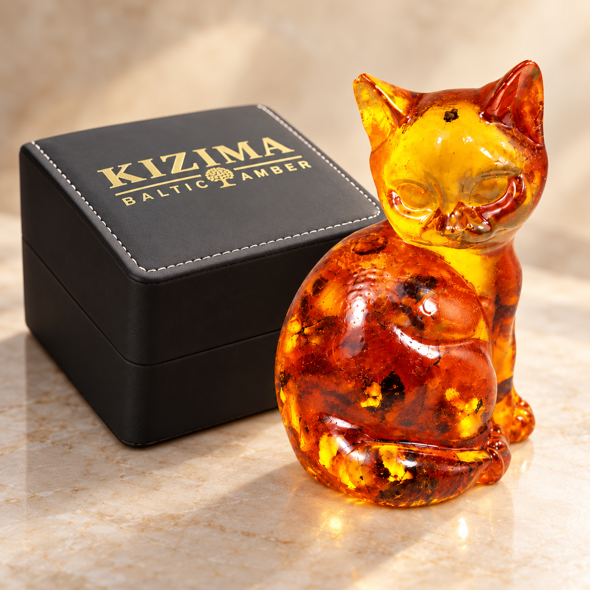 KIZIMA rounded amber cat beside the actual black stitched branded gift box