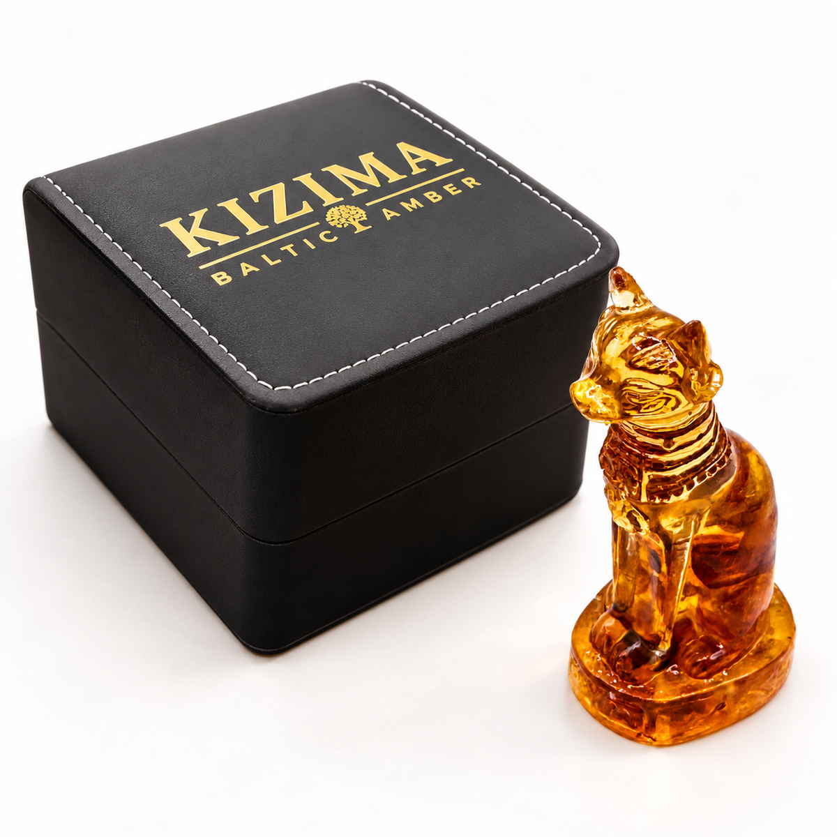 KIZIMA amber cat figurine beside the actual black stitched branded gift box