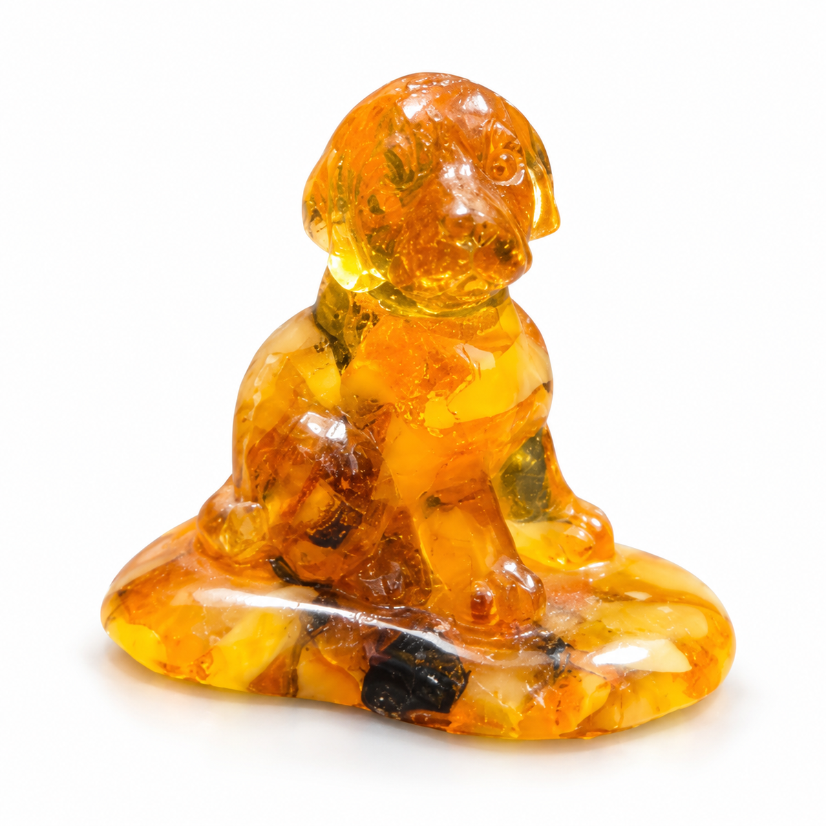 Seated puppy figurine on white, with golden amber patches through its body and a dark inclusion at the front of its oval base.