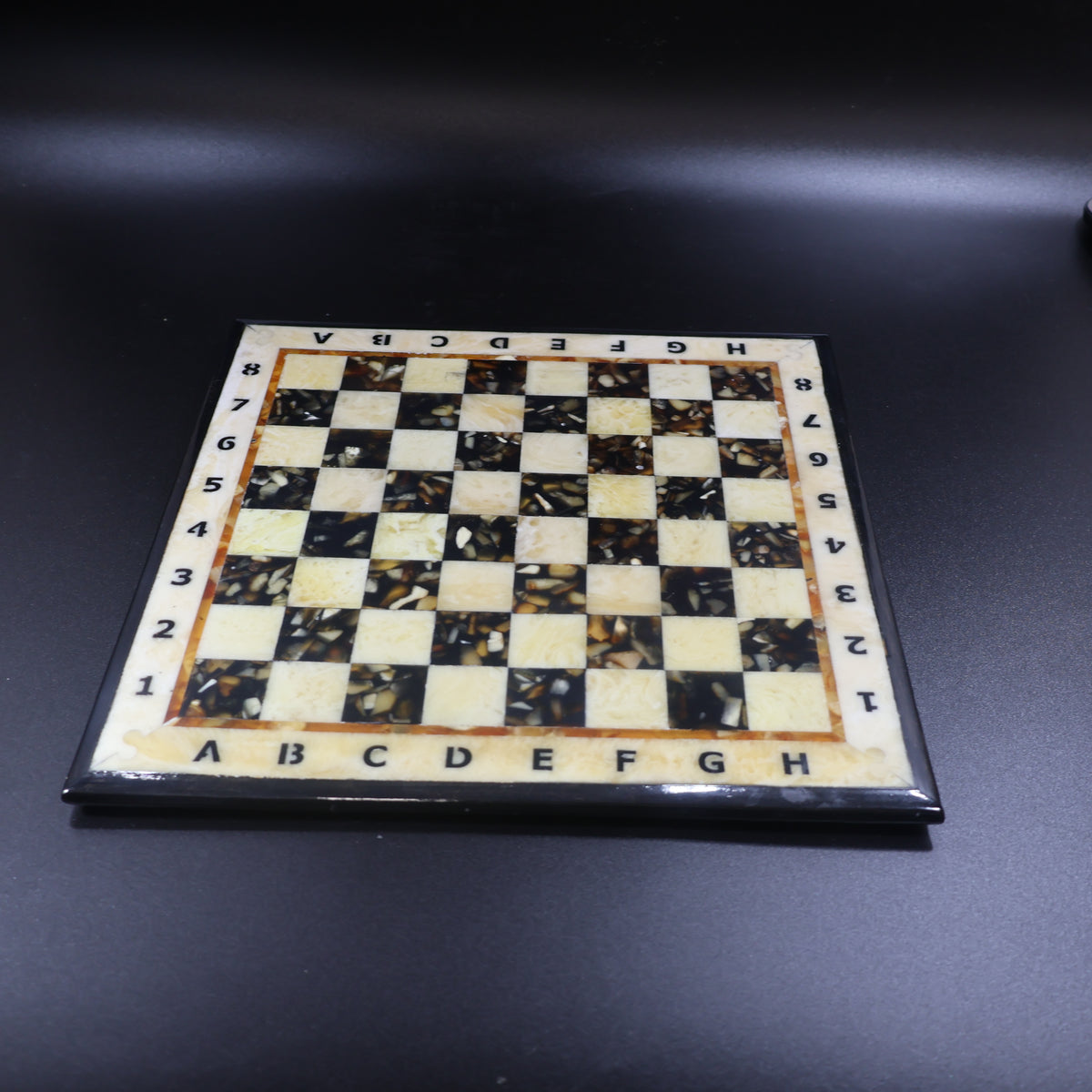 Amber inlay chess board close up, natural Baltic amber squares set in polished wood, made in USA KIZIMA