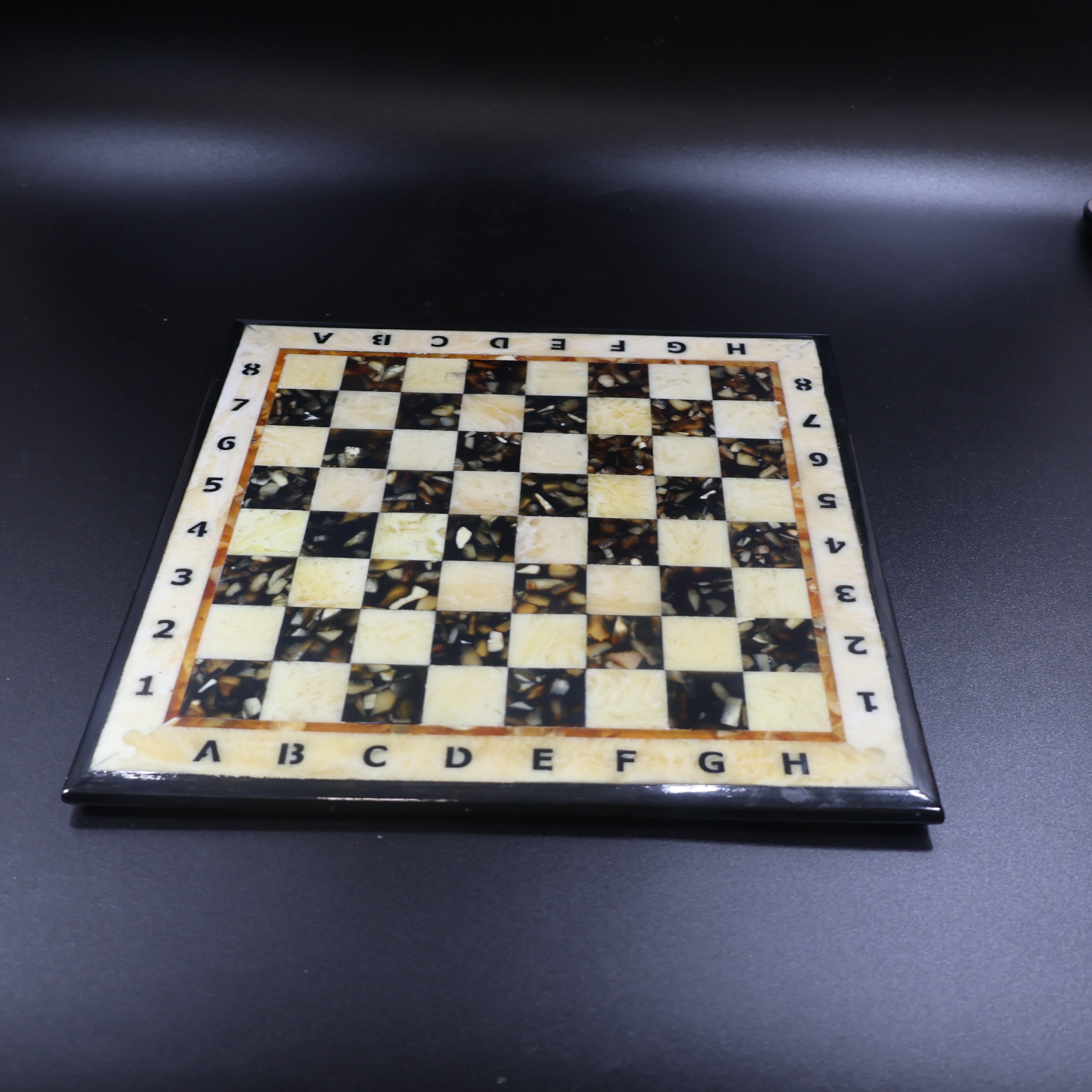Amber inlay chess board close up, natural Baltic amber squares set in polished wood, made in USA KIZIMA