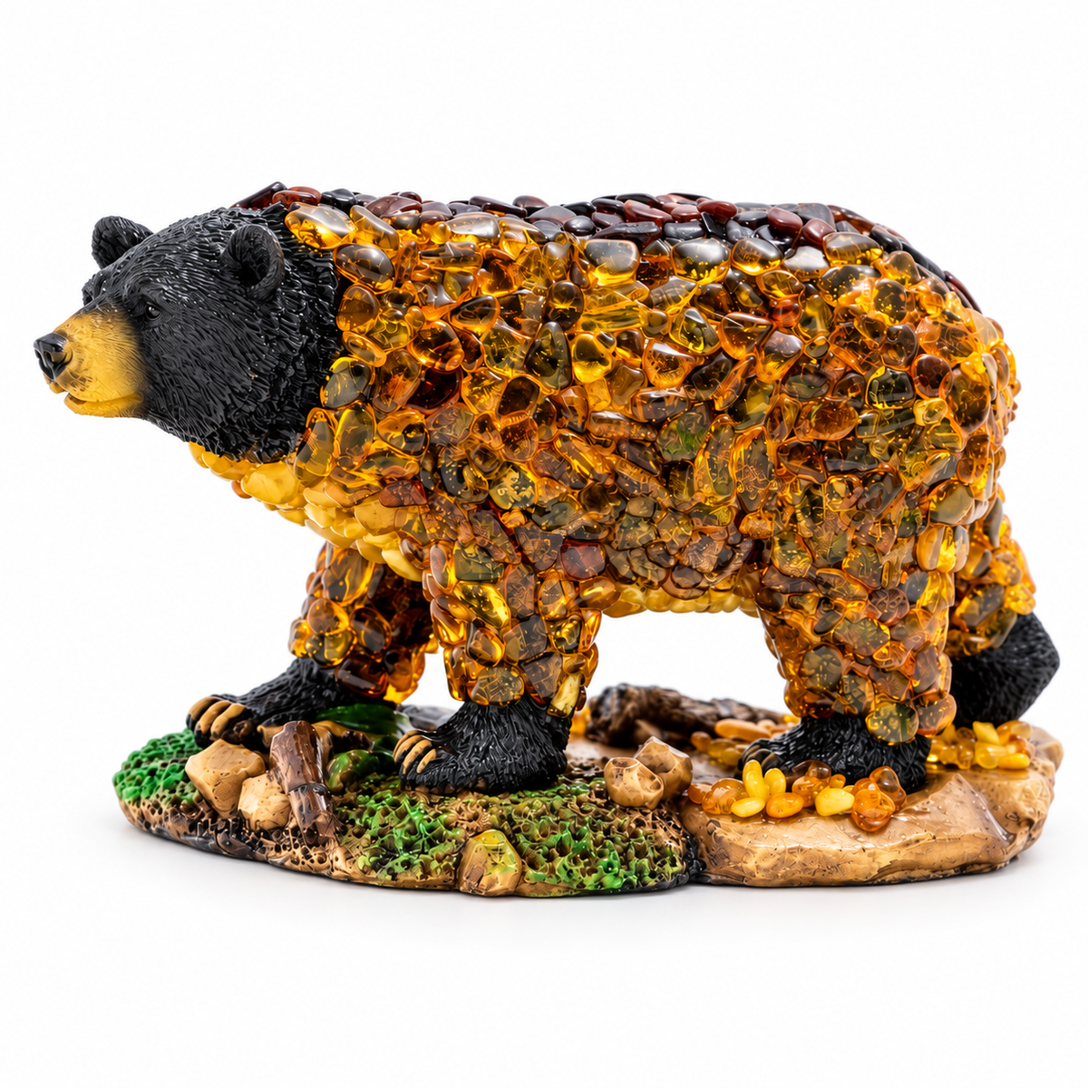 Standing amber mosaic bear with a black head and paws on a moss-accented rocky base, isolated on a white studio background.