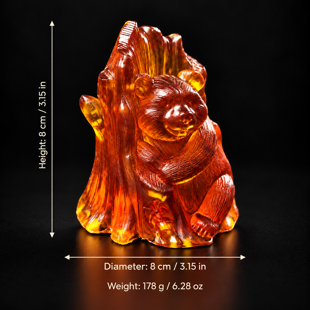 Amber bear with tree on a black background, labeled with height and diameter of 8 cm (3.15 in) and weight of 178 g (6.28 oz).