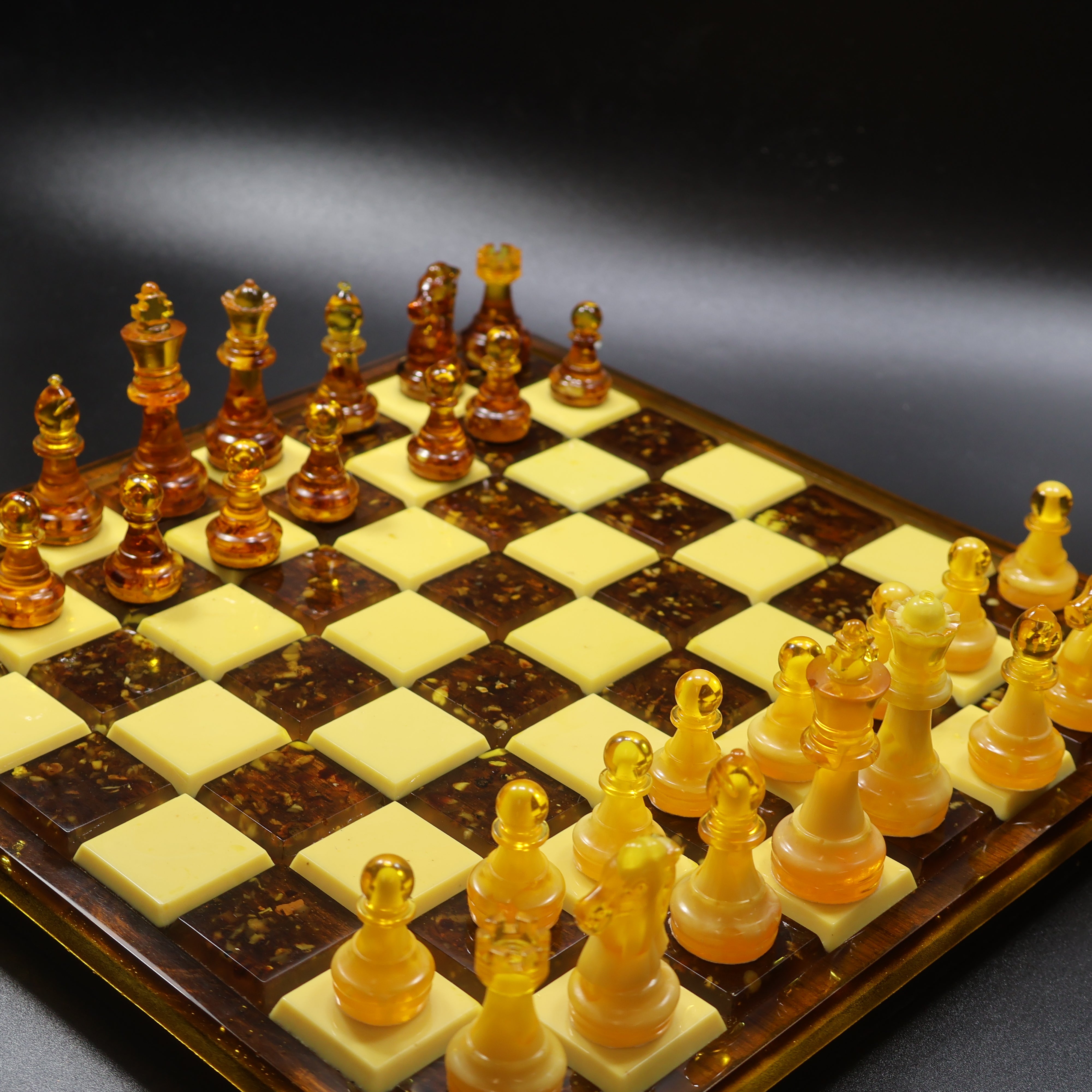 Amber chess set detail on rattan inlaid wooden board, natural Baltic amber king and queen pieces, KIZIMA handmade USA