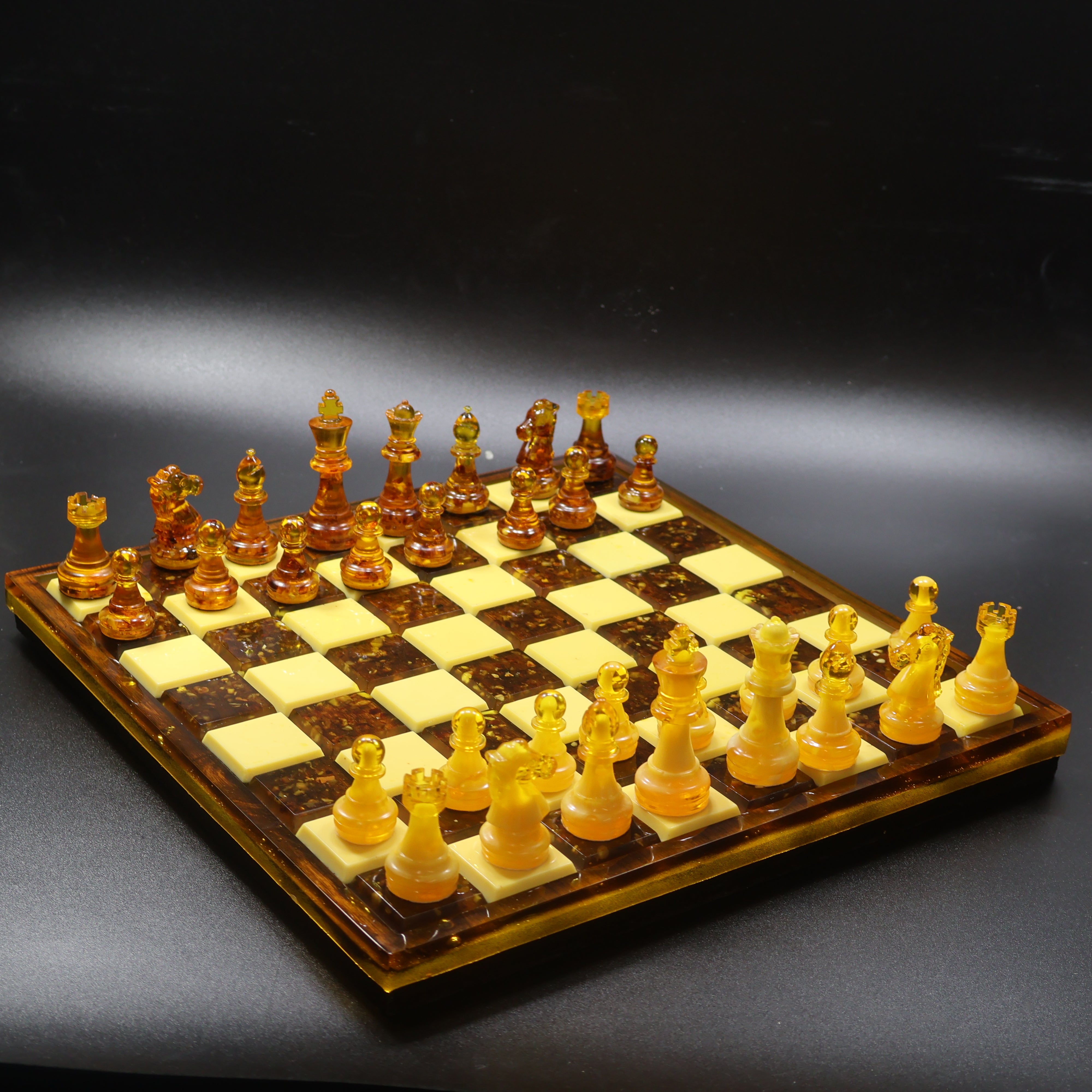 Full view of Baltic amber chess set with 32 pieces on natural rattan wood inlaid chess board, made in USA by KIZIMA
