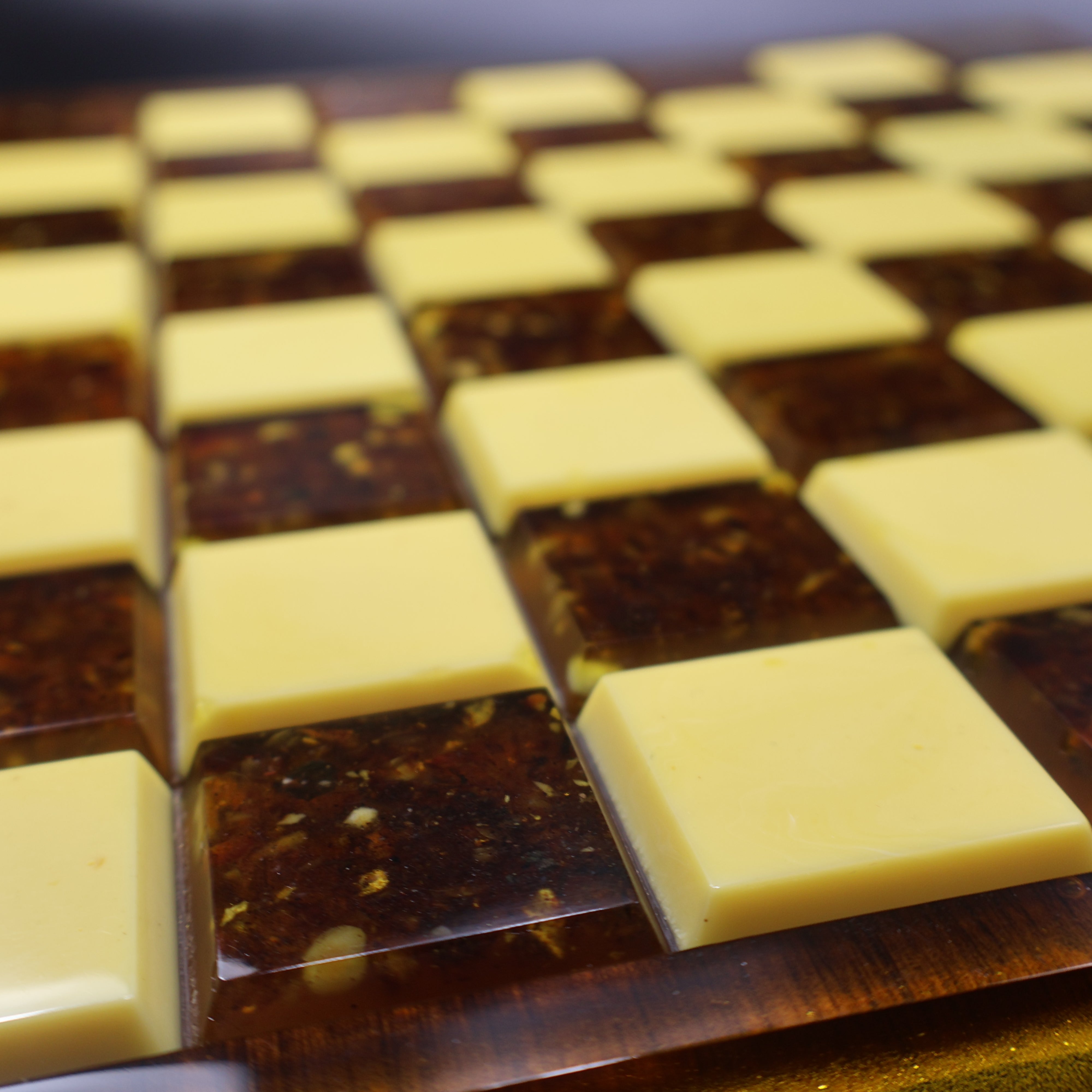 Baltic amber chess set close up on rattan wood chess board, natural amber pieces handcrafted in Brooklyn New York KIZIMA