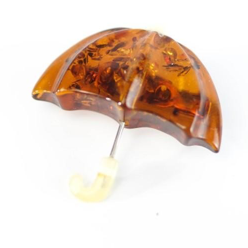 KIZIMA® umbrella brooch — genuine Baltic amber, handcrafted in USA, angled view