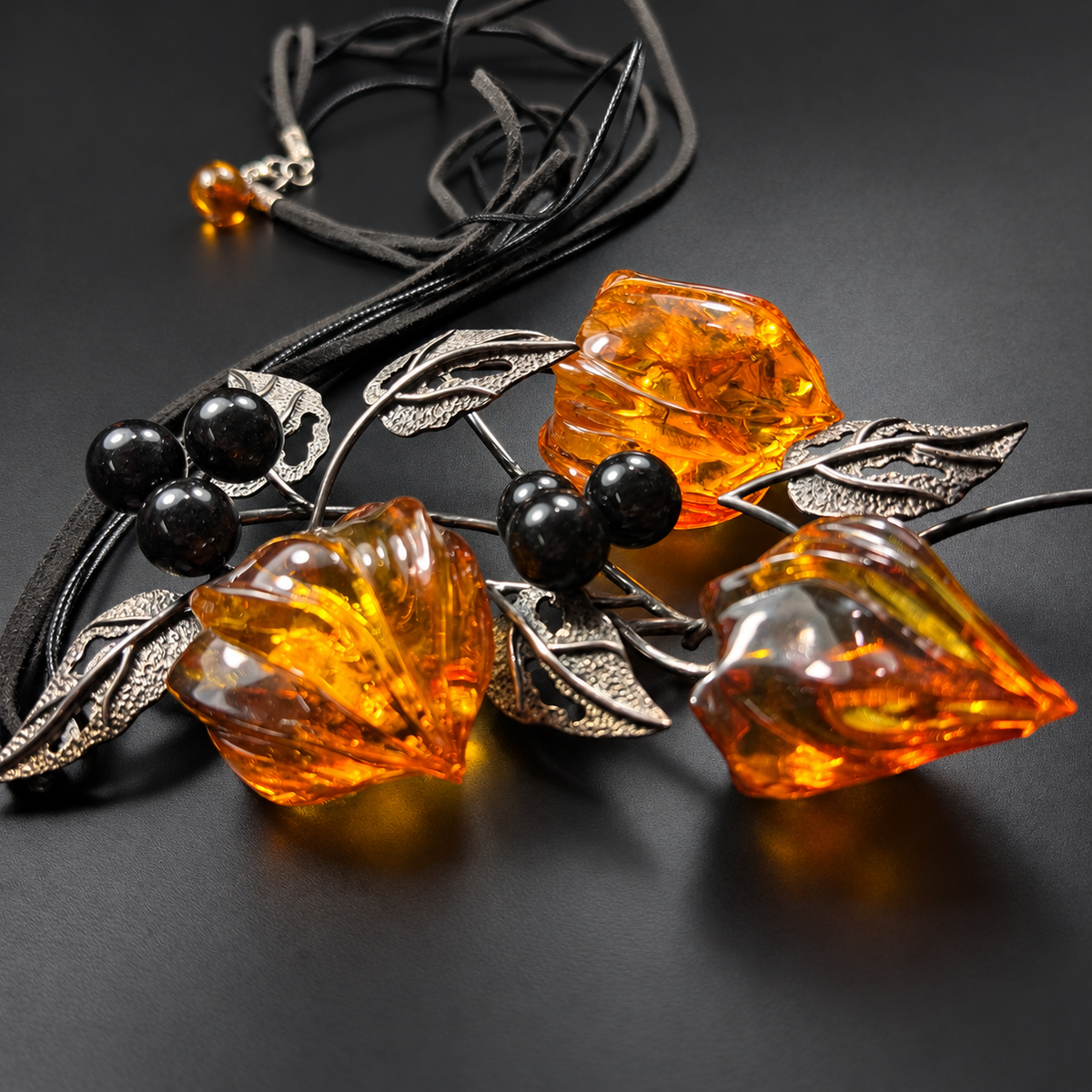 Low-angle view of amber physalis buds and leaf setting on charcoal, studio view 4