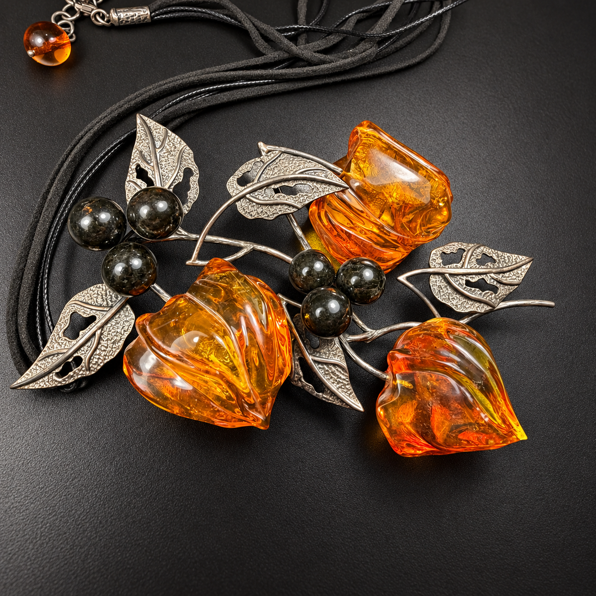 Overhead detail of amber physalis necklace with pierced leaf branches, studio view 7