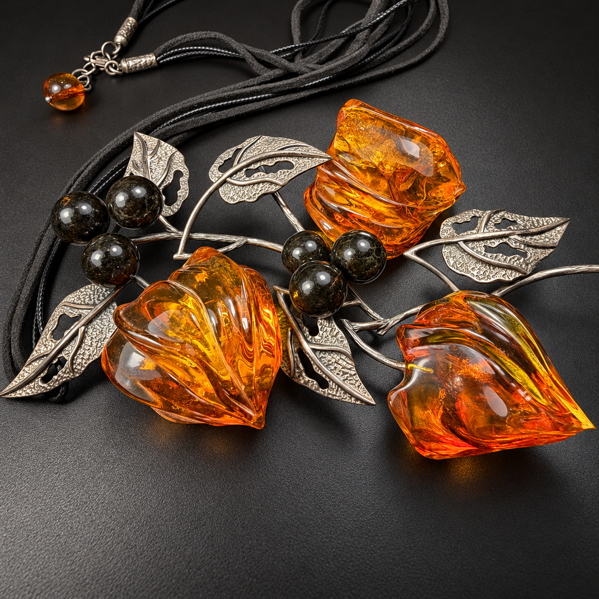 Angled close-up of three honey-orange carved amber buds, studio view 8