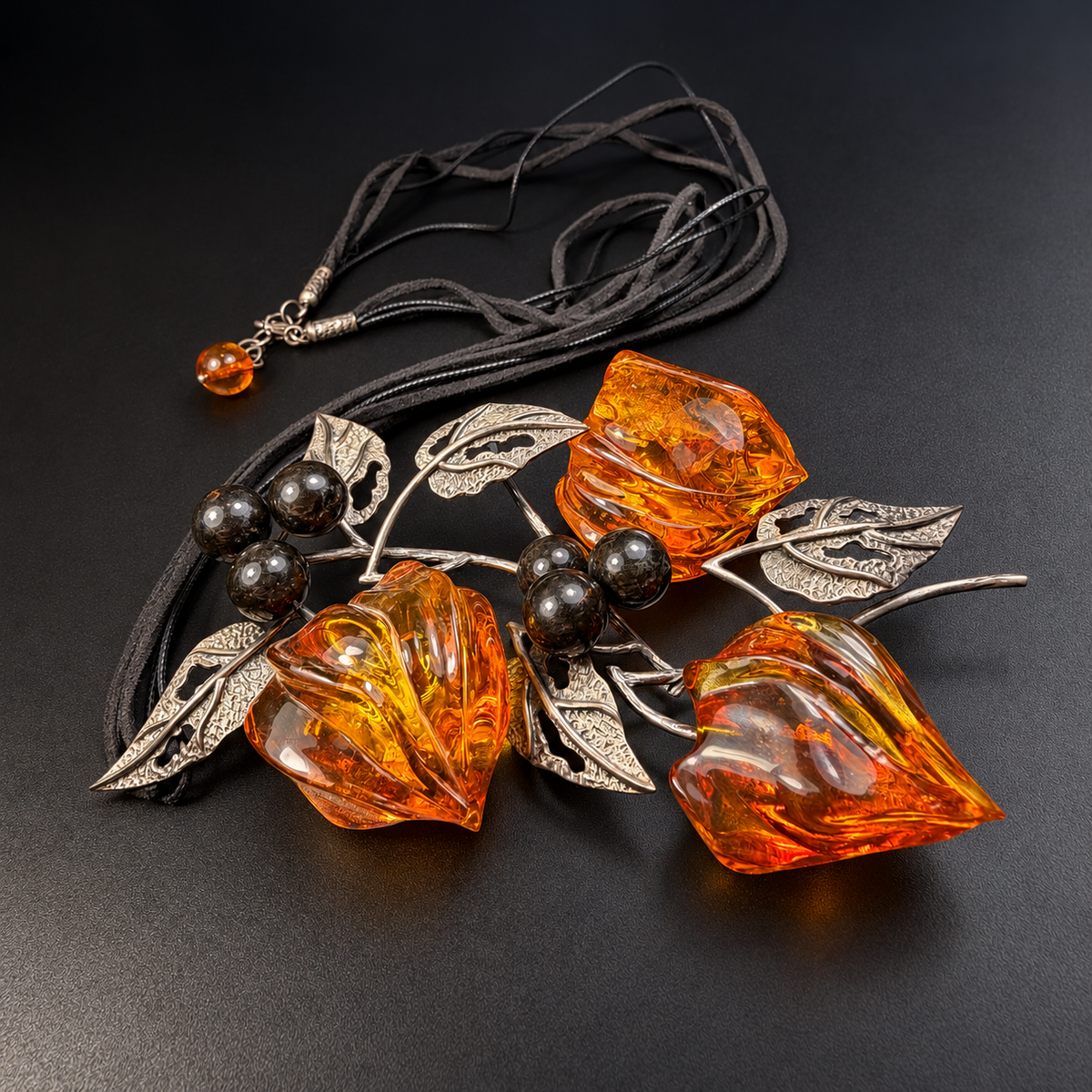 Full angled amber necklace showing cords, clasp and amber drop, studio view 9