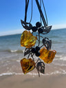 Handmade Baltic amber necklace with carved blossoms and silver leaves, by KIZIMA New York