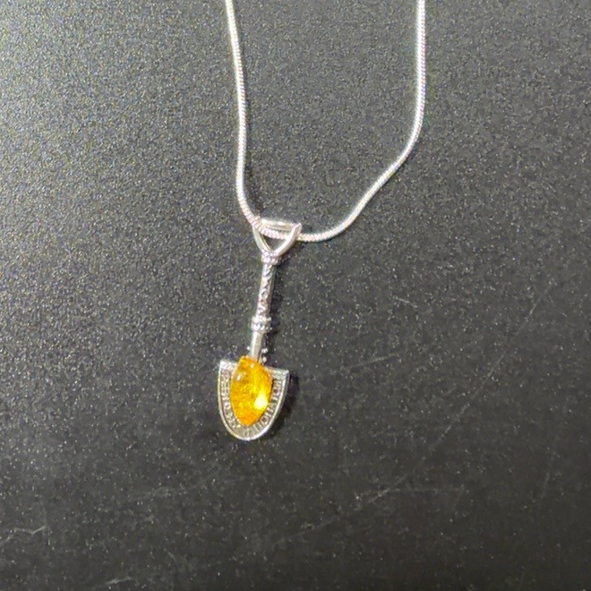 Original close detail of the Natural Baltic Amber silver money shovel pendant on chain