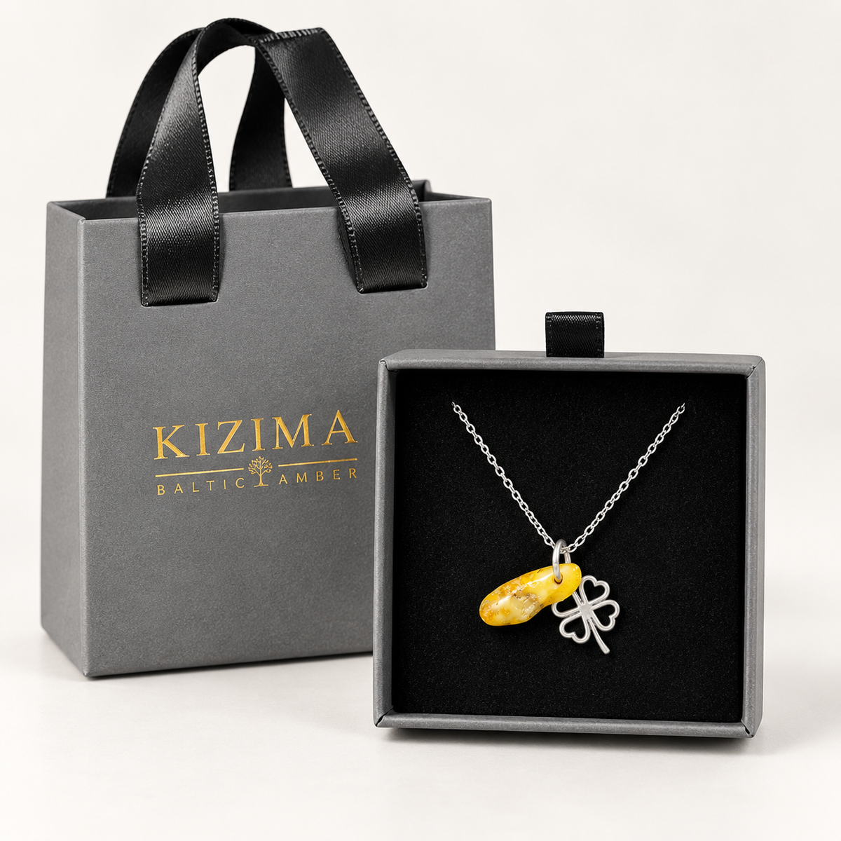 Made in USA Natural Baltic Amber clover necklace by KIZIMA® in the premium drawer-style gift box with matching ribbon-handle gift bag