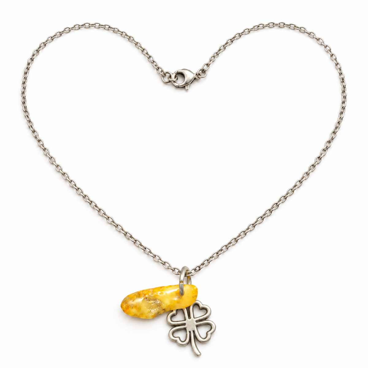Made in USA Natural Baltic Amber four-leaf clover pendant necklace by KIZIMA® with heart-shaped chain arrangement on white