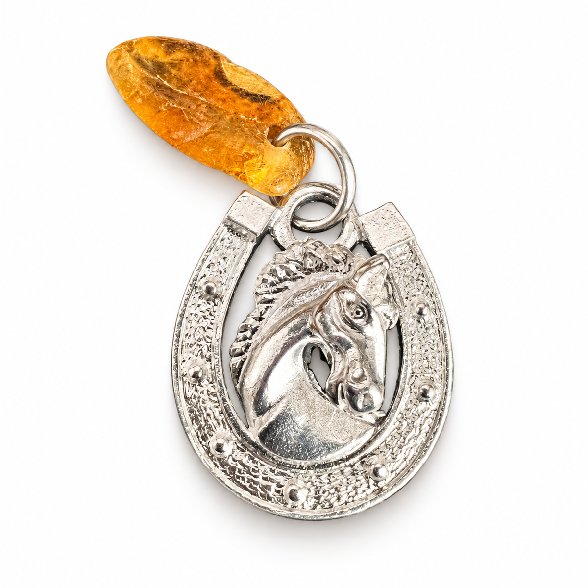 KIZIMA horseshoe horse head amulet with a separate golden amber piece and metal joining ring on a white background