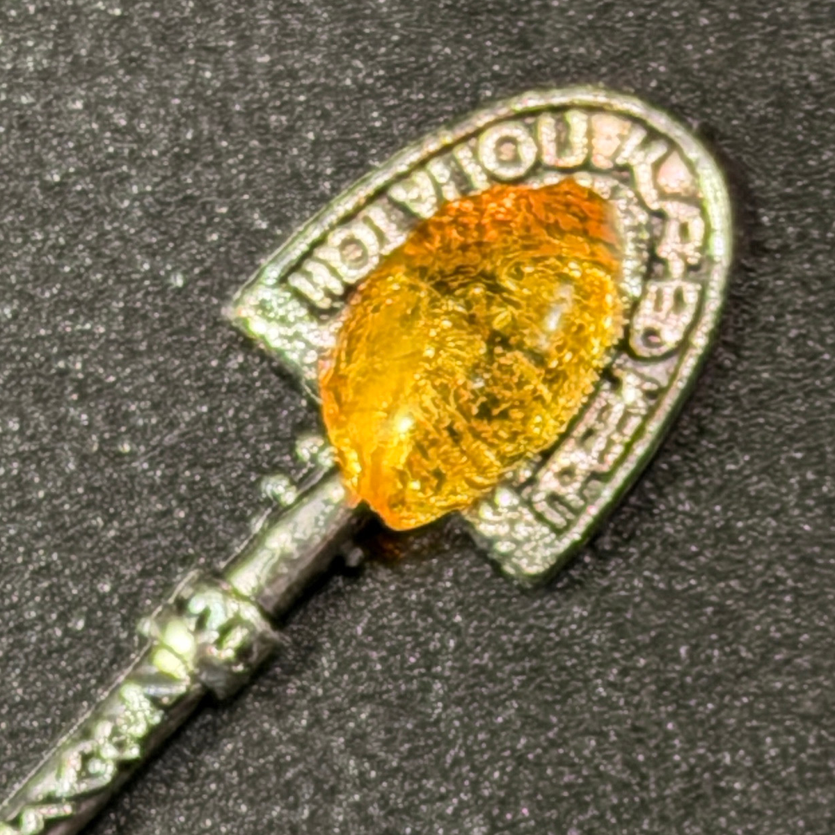 Original macro photograph of the money shovel amber and Russian inscription