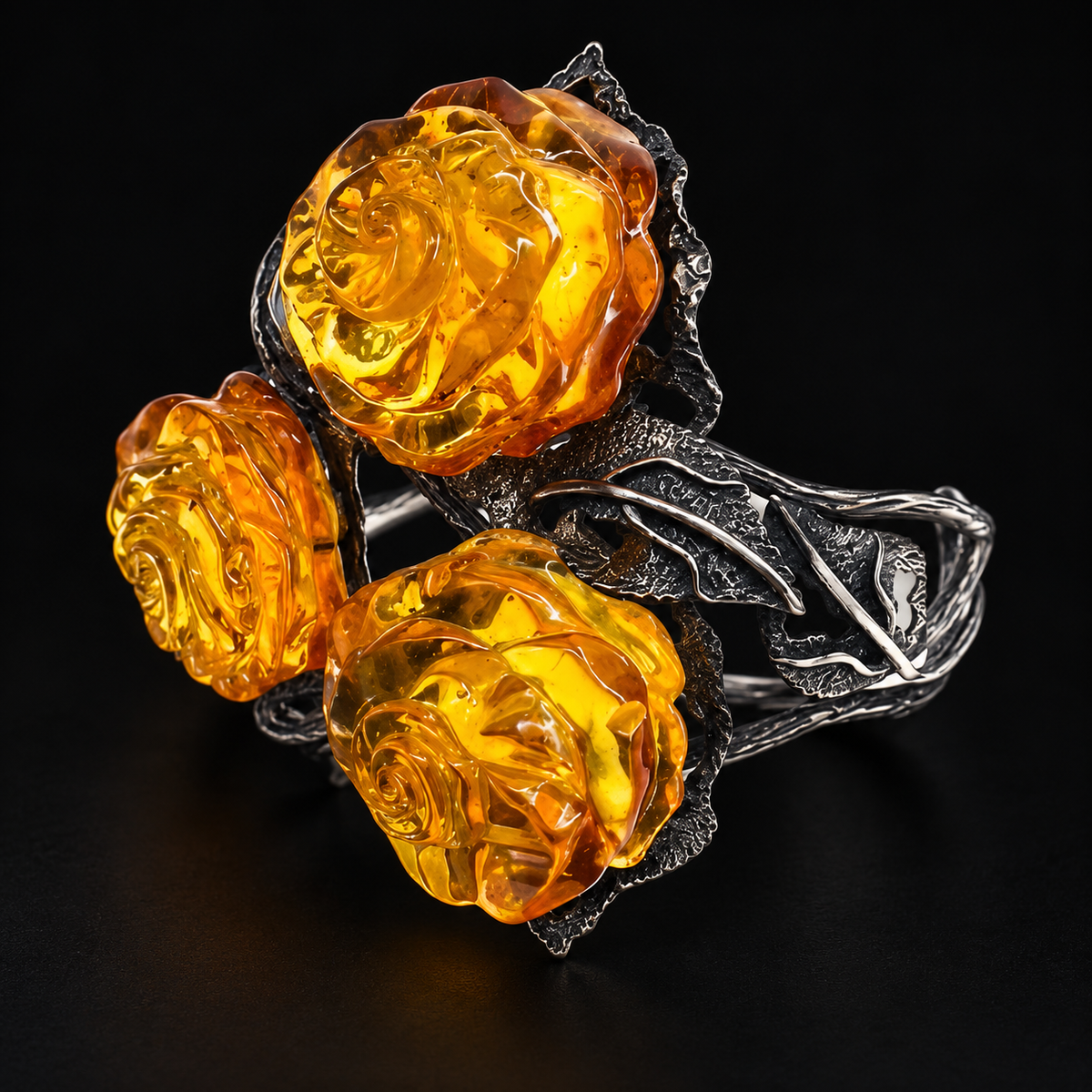 KIZIMA 3E30000q67.1 cuff with three carved honey amber roses and silver-tone leaves on a black studio surface