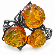 KIZIMA 3E30000q67.1 cuff with three carved honey amber roses and silver-tone leaves isolated against pure white