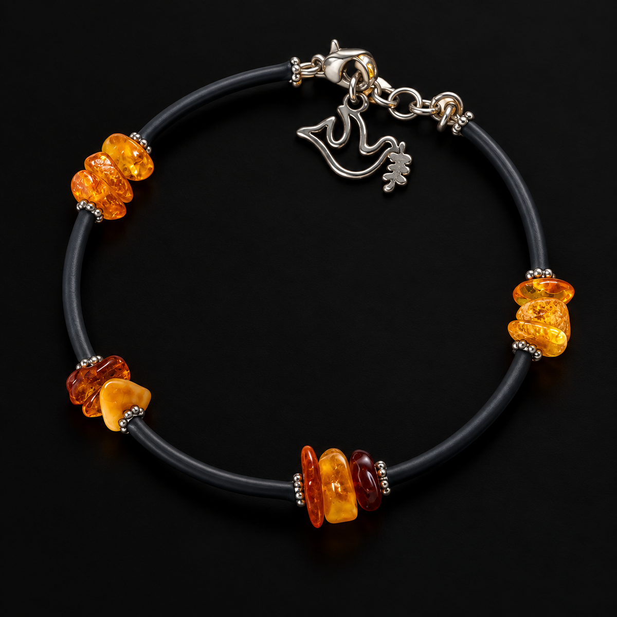 KIZIMA 3G0075q5 amber chip bracelet with black cord and silver dove charm on a black studio background