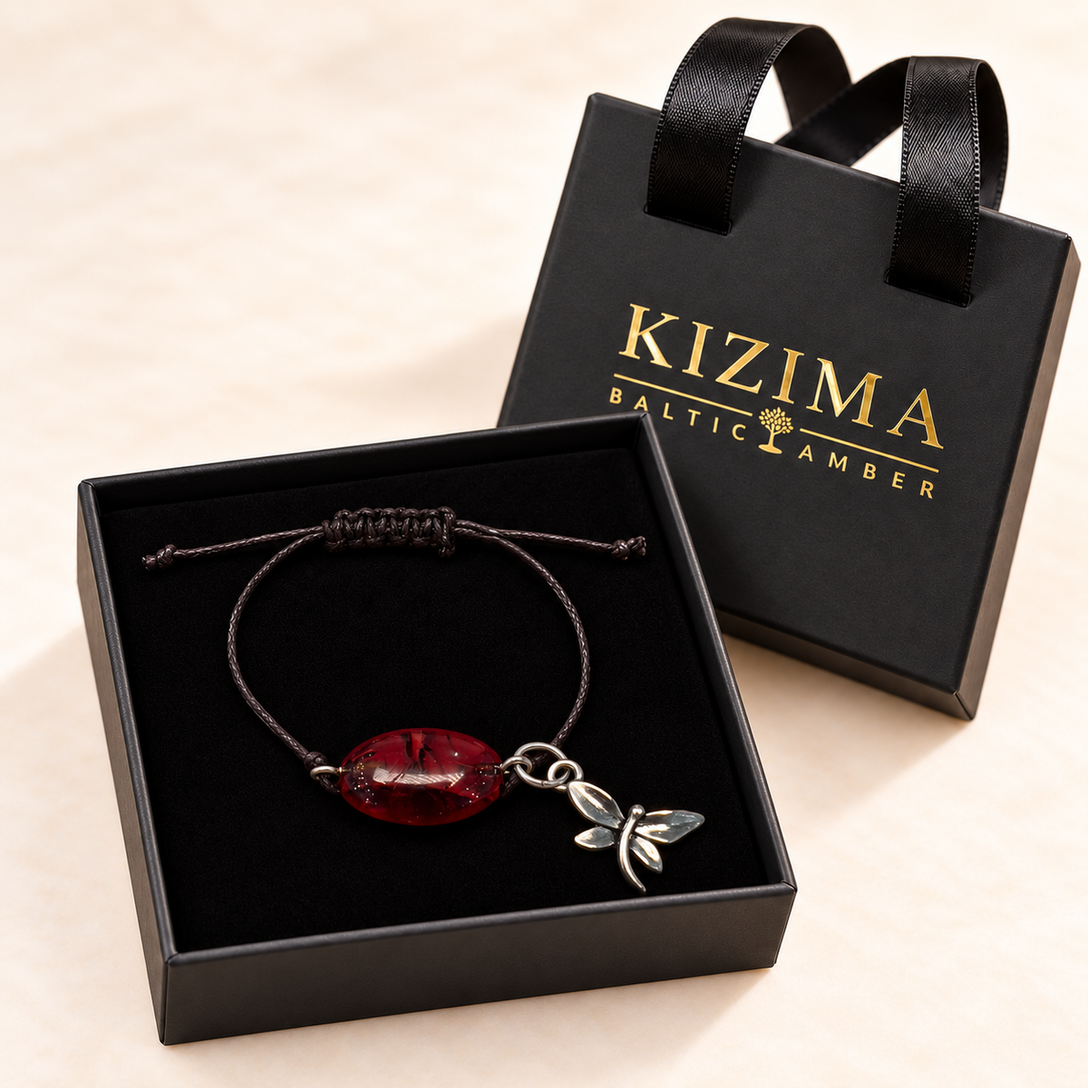 KIZIMA 3G0100q2.69 dark cherry oval amber cord bracelet with silver-tone dragonfly charm in the KIZIMA black velvet gift box