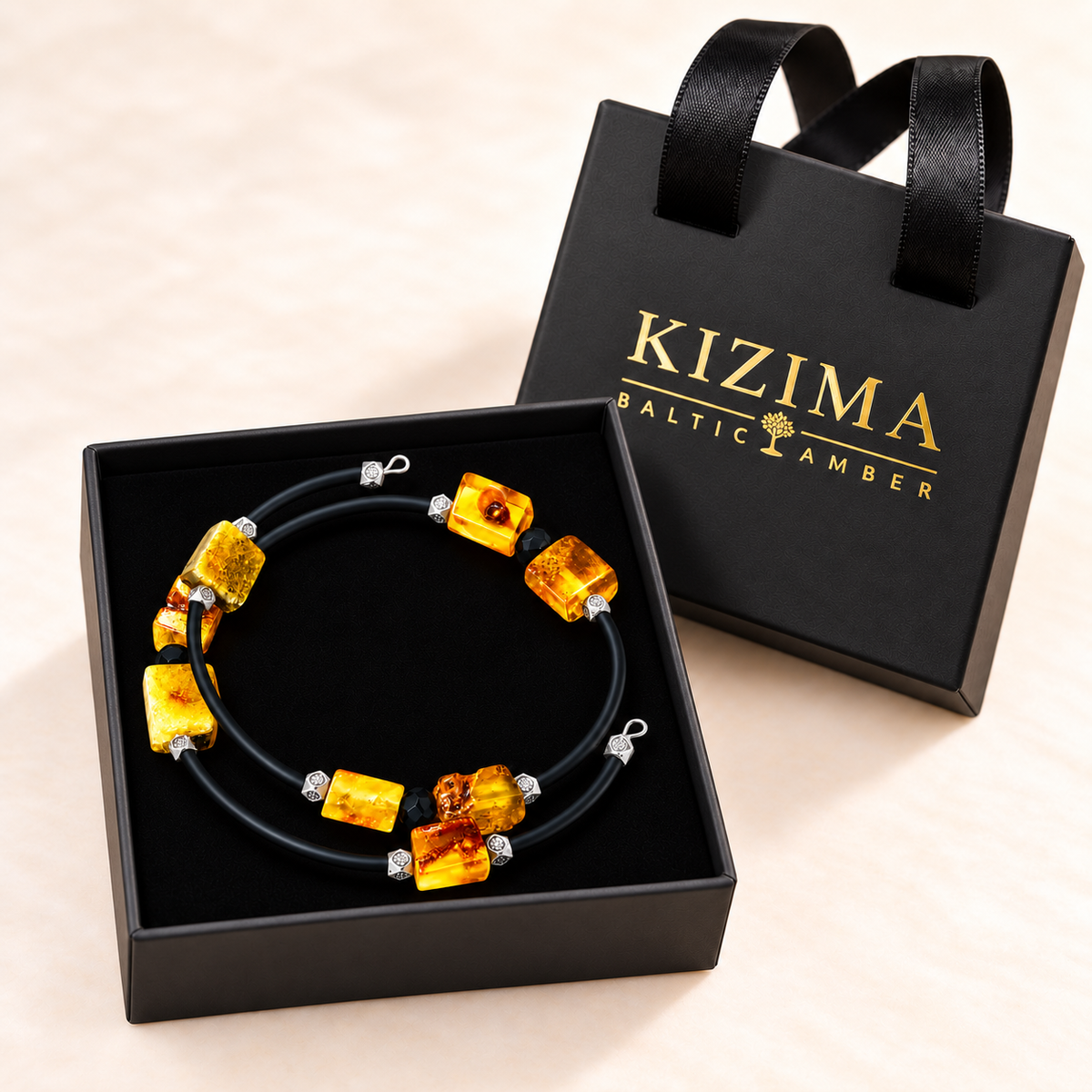 Yellow amber spiral bracelet displayed on spotless black velvet in a KIZIMA gift box