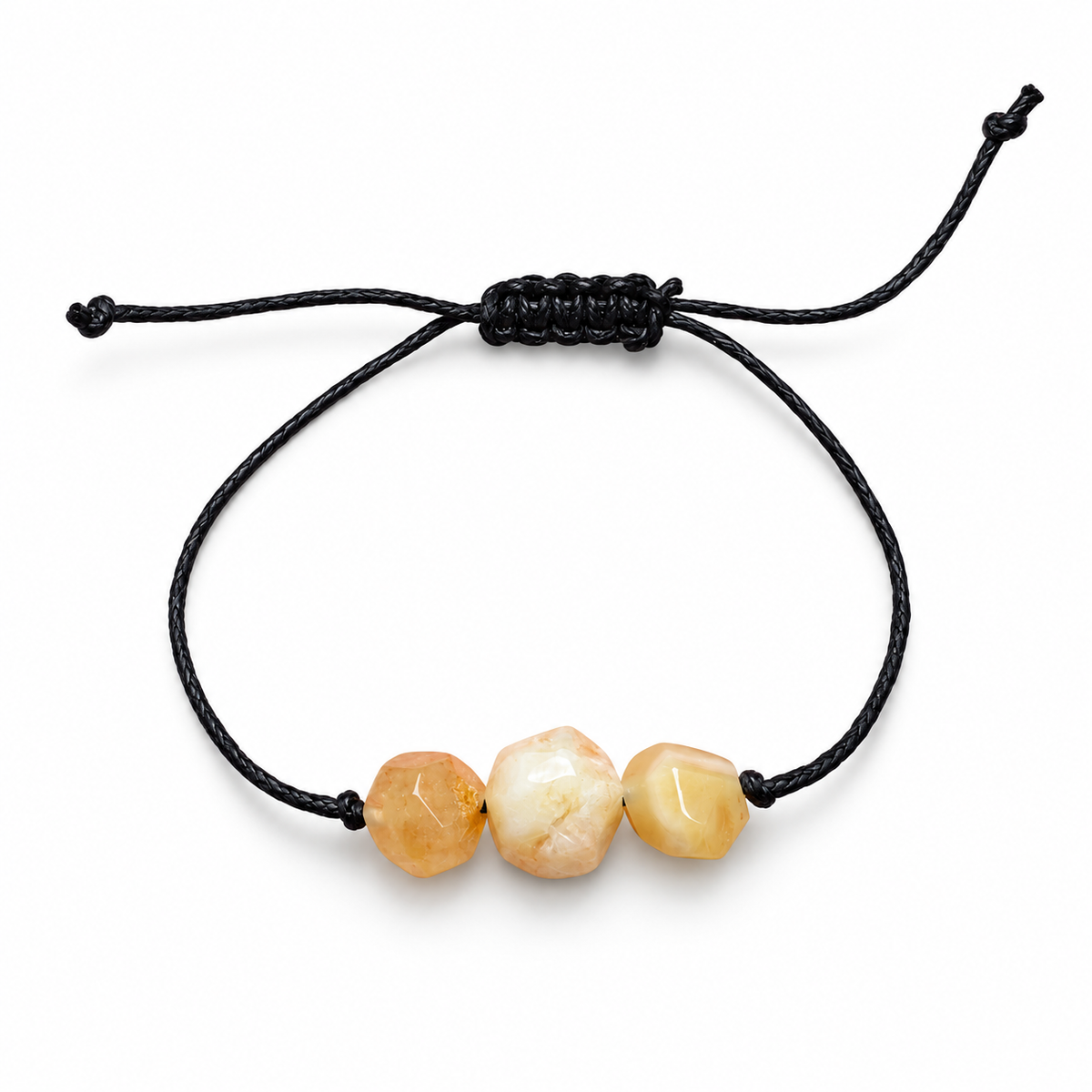KIZIMA three faceted cream and peach amber stones on an adjustable black cord bracelet against pure white.