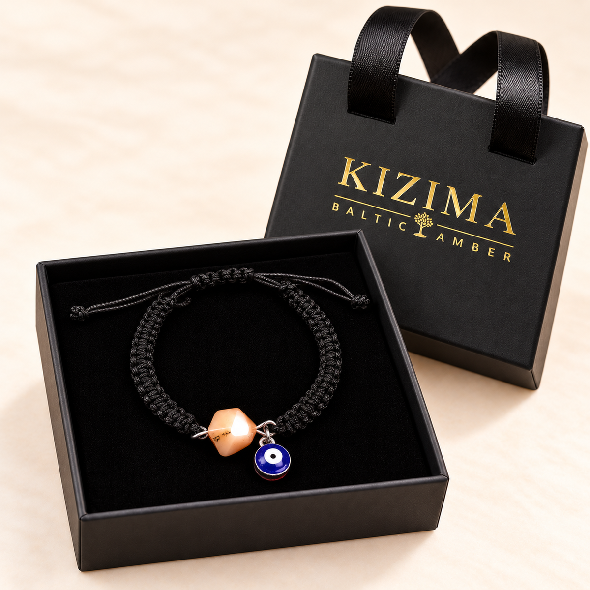 KIZIMA 3G0125q2.76-2 pale peach amber black macrame bracelet with blue evil-eye charm in the KIZIMA black velvet gift box